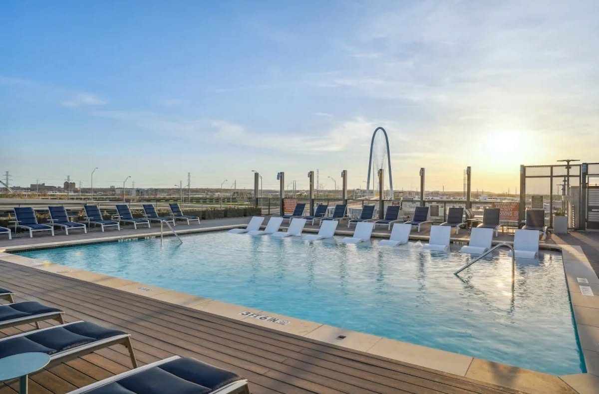 Rooftop apartment pool at sunset with the Margaret Hunt Hill Bridge in the distance, Dallas